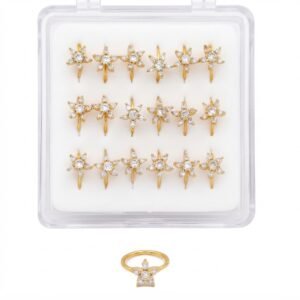 Elegant gold nose rings with flower design and stones in a display case